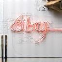 Detailed design sketch or pattern for a neon sign on a workbench